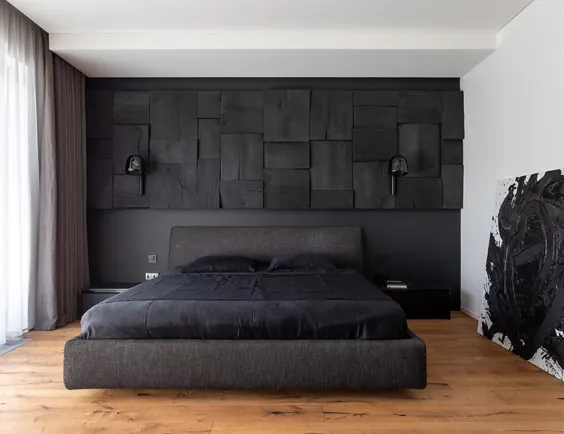 یک دیوار لهجه چوب سیاه شده ، برخی از بافت های خلاقانه را در این اتاق خواب ارائه می دهد
