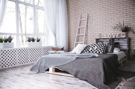 اتاق خواب مدرن با تخت دونفره راحت و دیوار آجری سفید شیک