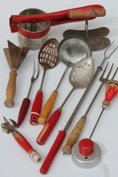 ظروف آشپزخانه پرنعمت با دستگیره های قرمز ، قاشق های چوبی رنگ شده قرمز ، چنگال های نان تست ، ابزار هلی کوپتر